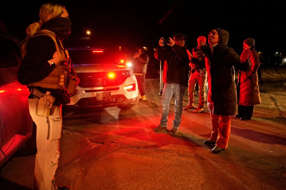 A woman confronts a federal immigration officer at the scene of a reported shooting, Jan. 14, 2026, in Minneapolis.