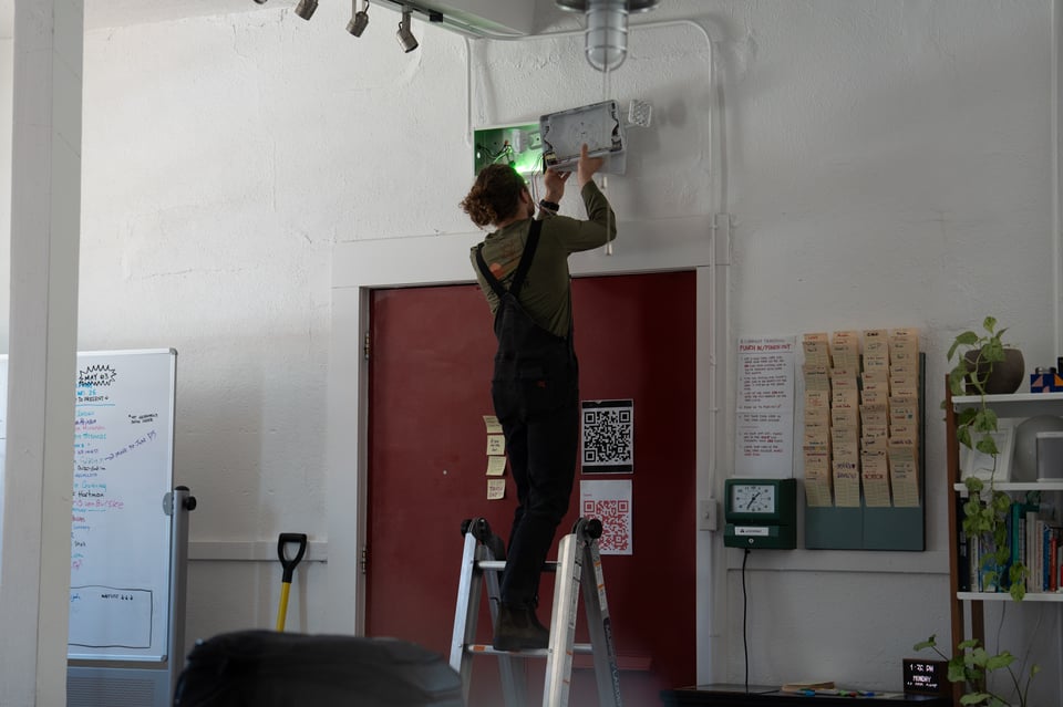 Jim installing a new exit sign.