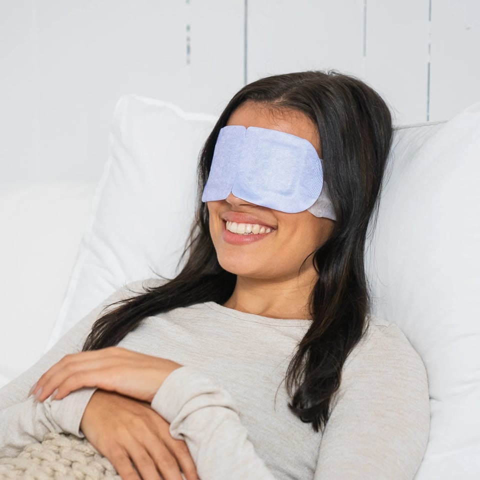 a woman wearing a blue eye mask