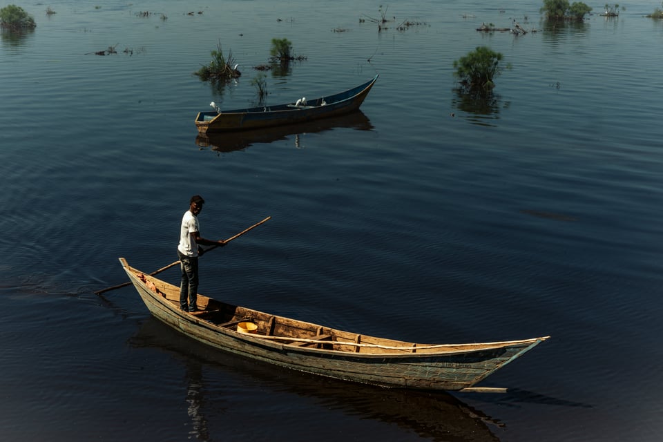 A fisherman standing in a boat