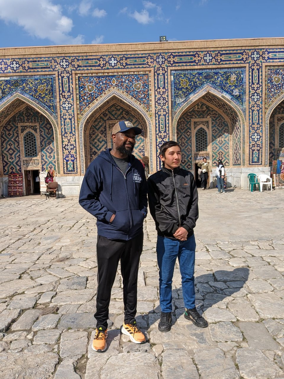 Nate posing with a young local man in Samarkand