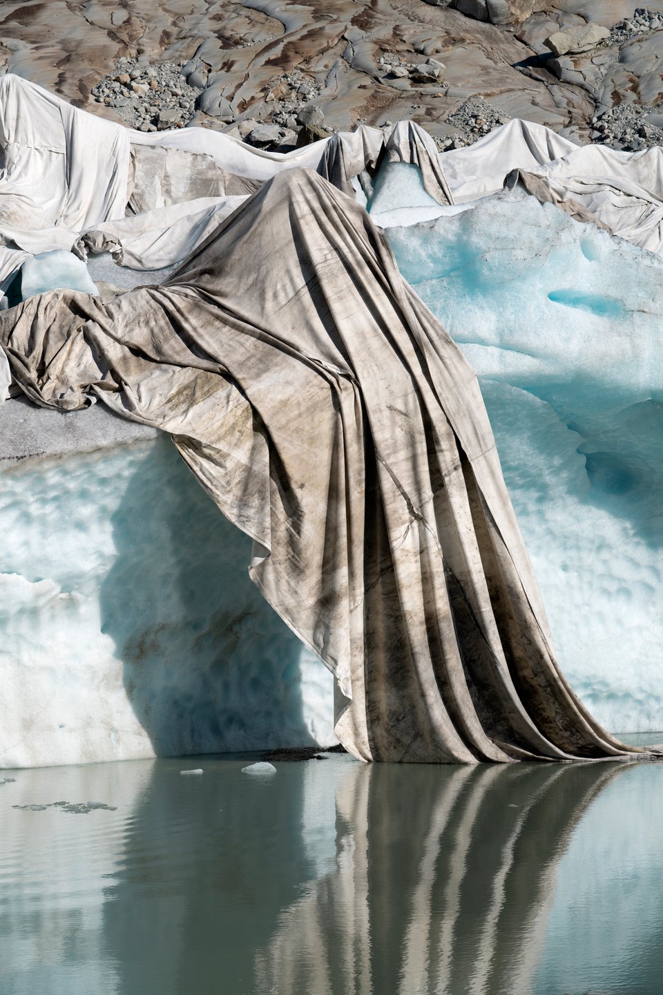 Close up of glacier ice, partially draped with a blanket.