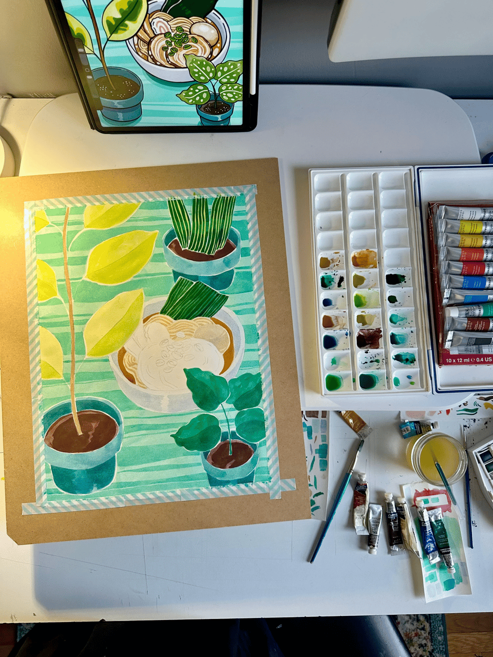 The ramen painting in progress, taped to a mortarboard with watercolor and gouache tubes