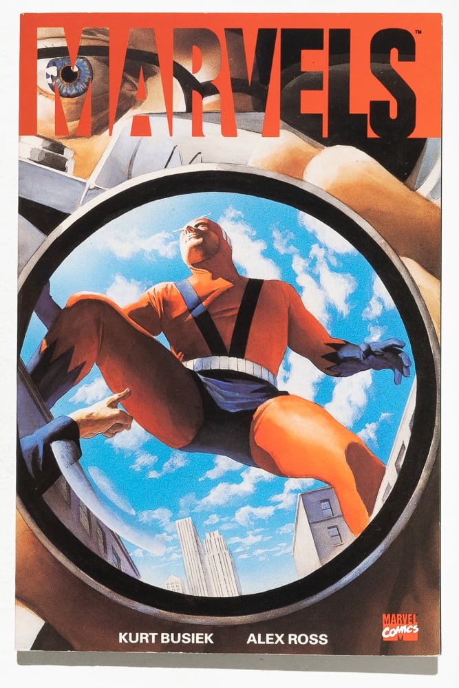 The cover of the first TPB printing of "Marvels" by Kurt Busiek and Alex Ross. It shows a Giant Man crotch shot reflected in the lens of a camera