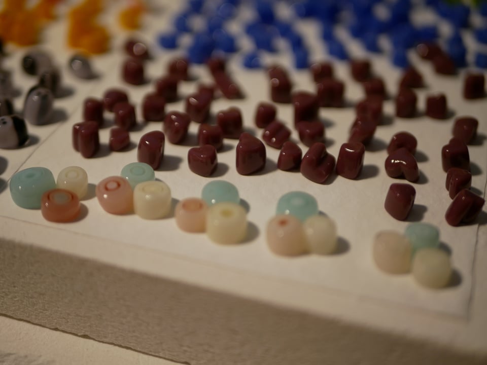 kiln shelf with trans pride blobs in focus and hearts in the background