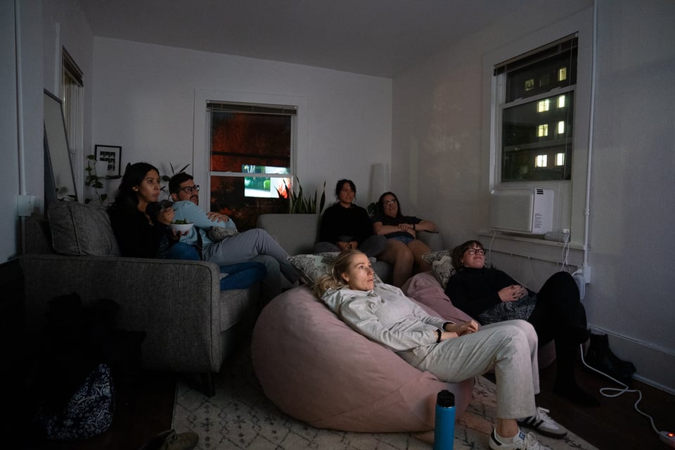 A group sitting in a dark room.