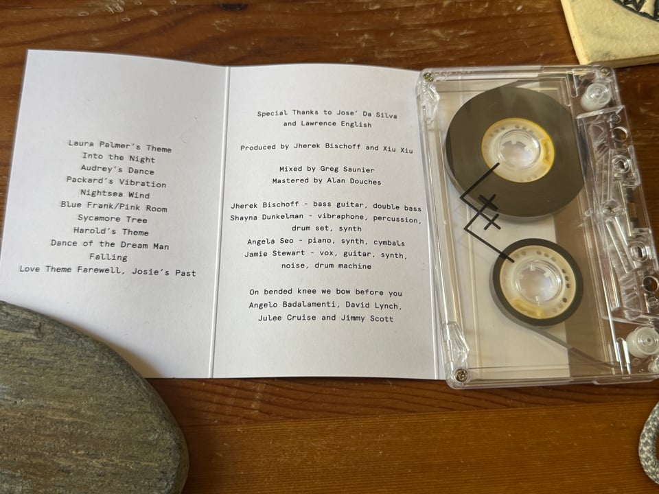 The liner notes of the cassette for Xiu Xiu Plays the Music of Twin Peaks. Includes a track listing, performers, and a dedication to the creators of Twin Peaks and its score.