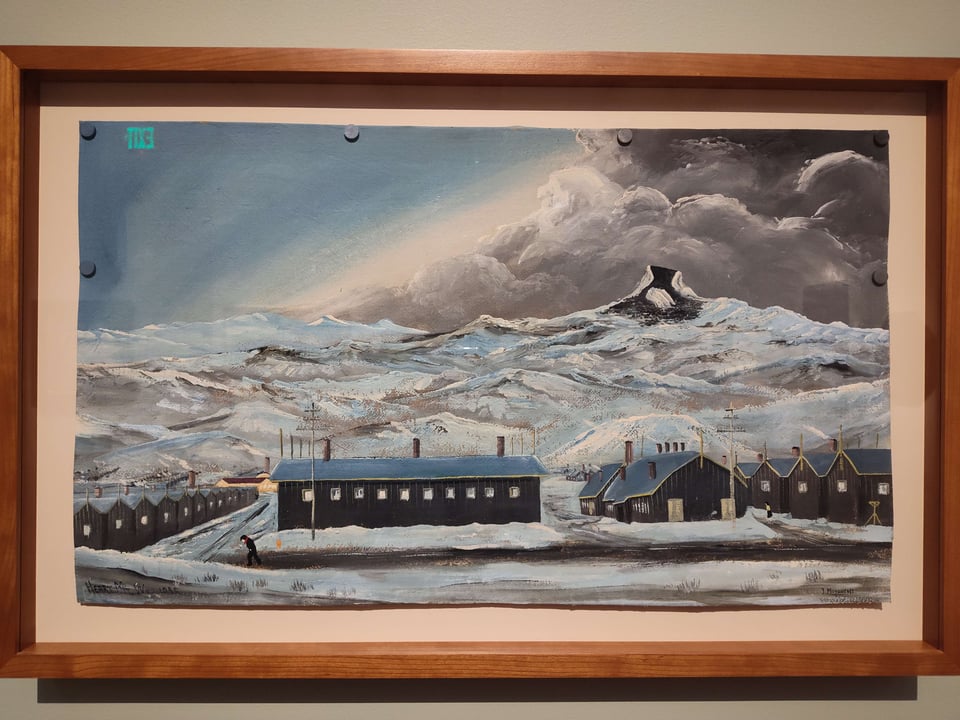 A painting of Heart Mountain Relocation camp with snowy buildings in the front and the mountain in the back.