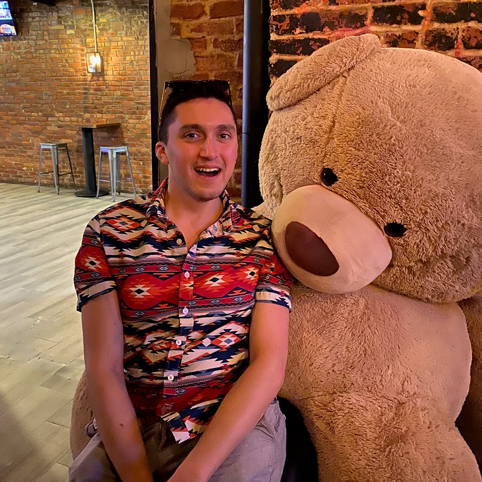 The author sitting on a big teddy bear