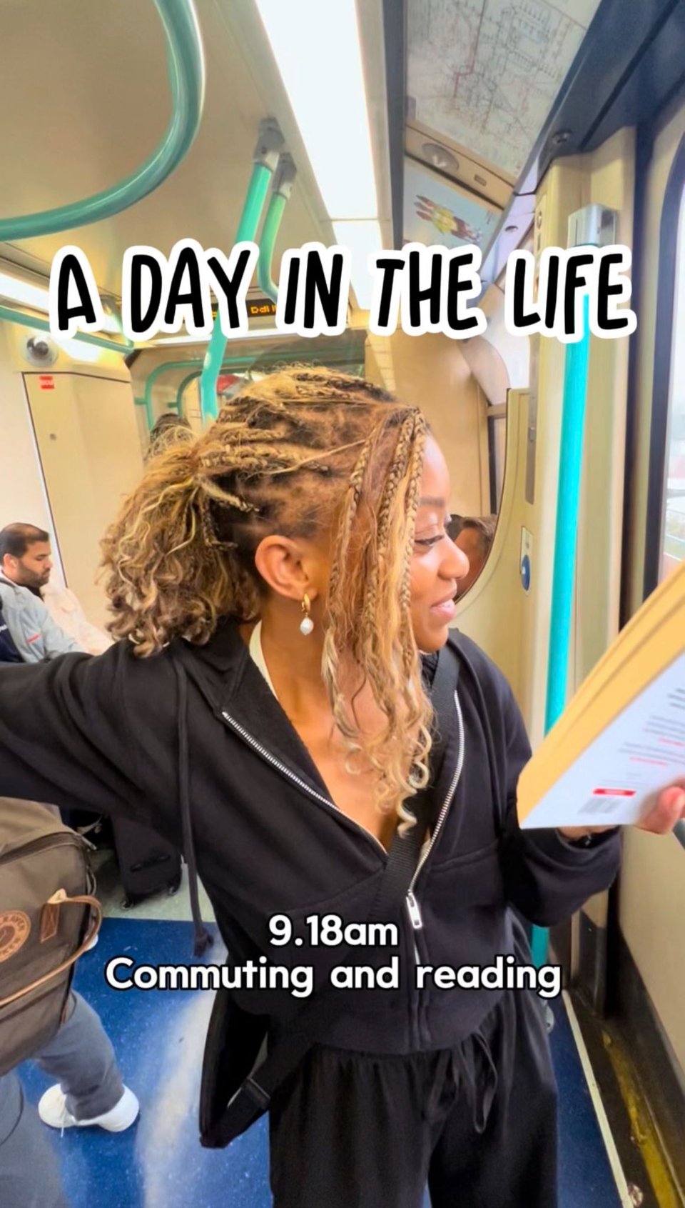 Me standing on public transport, reading a book while holding onto a pole. Text on the image reads, “A Day in the Life — 9.18am Commuting and reading.”