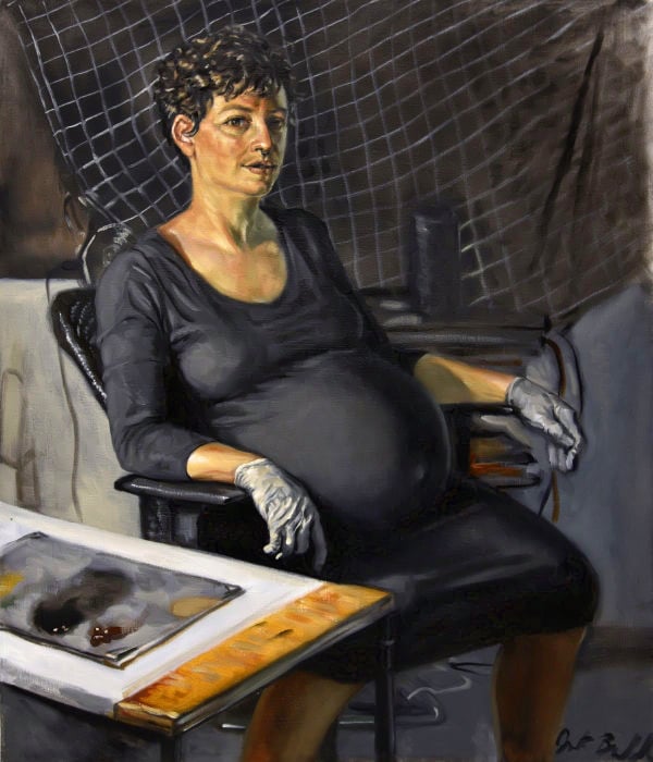 Painting of an olive-skinned white woman with short dark hair, heavily pregnant, wearing a stretchy black dress and gray disposable gloves, and seated in an office chair, next to a wooden cart with a paint palette on it, and in front of a drape with a white on black grid.