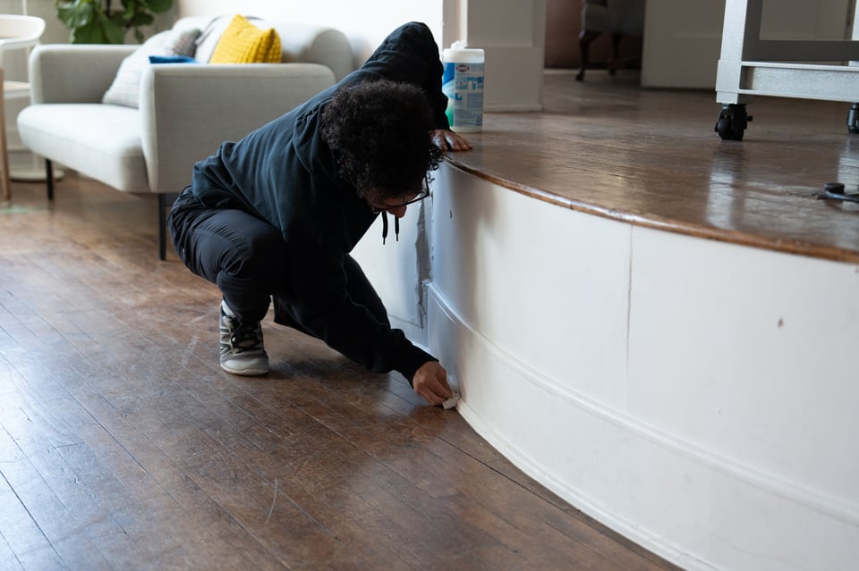 Mark spot-cleaning a wall.