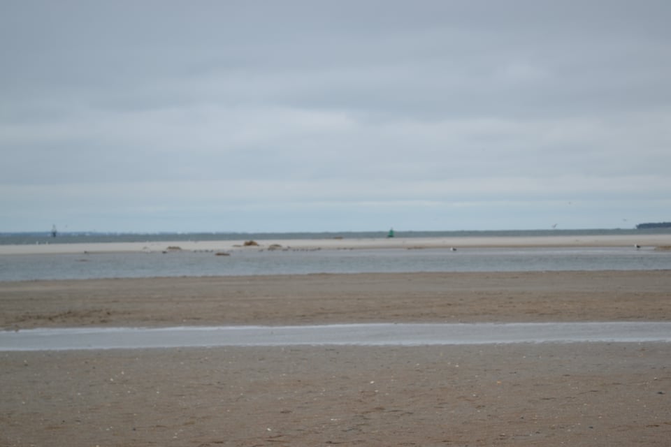 An open, flat, sandy beach.