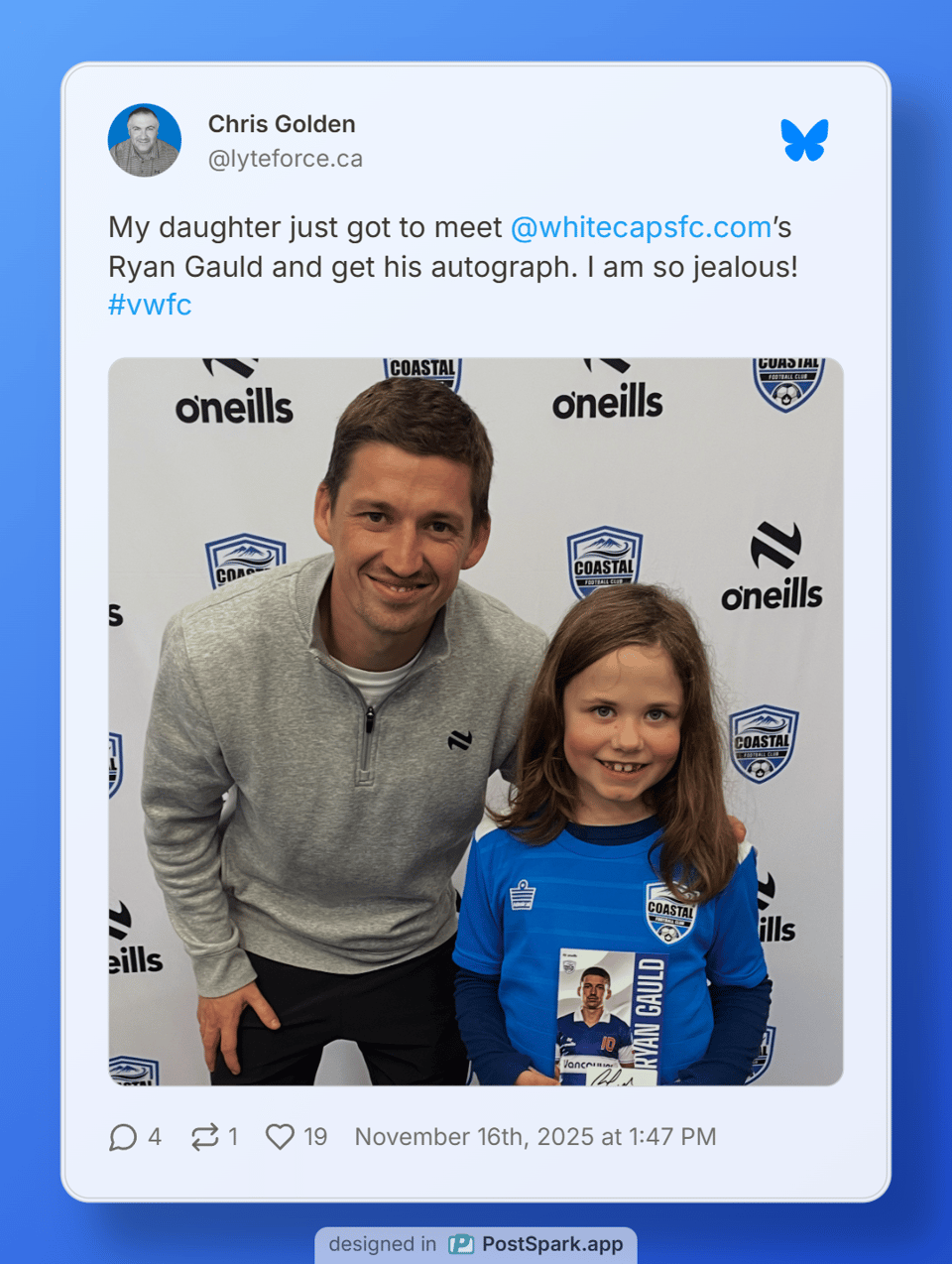 Ryan Gauld standing next to a young girl wearing a soccer uniform holding a signed Ryan Gauld card.