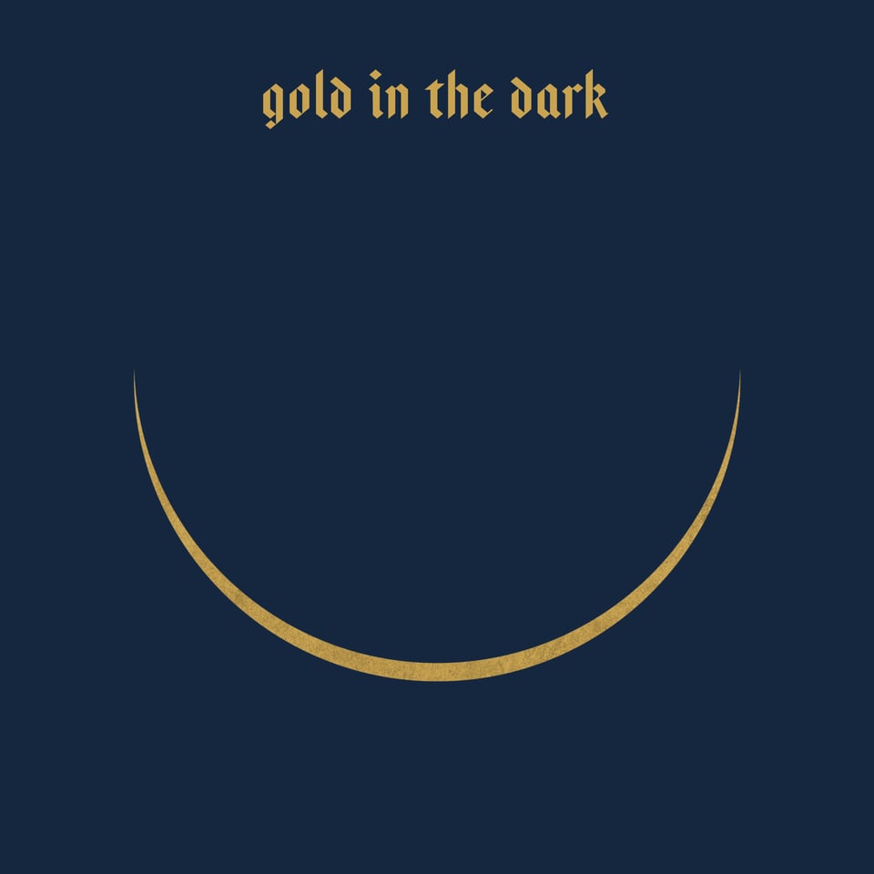 navy background with 'gold in the dark' written above a crescent moon.