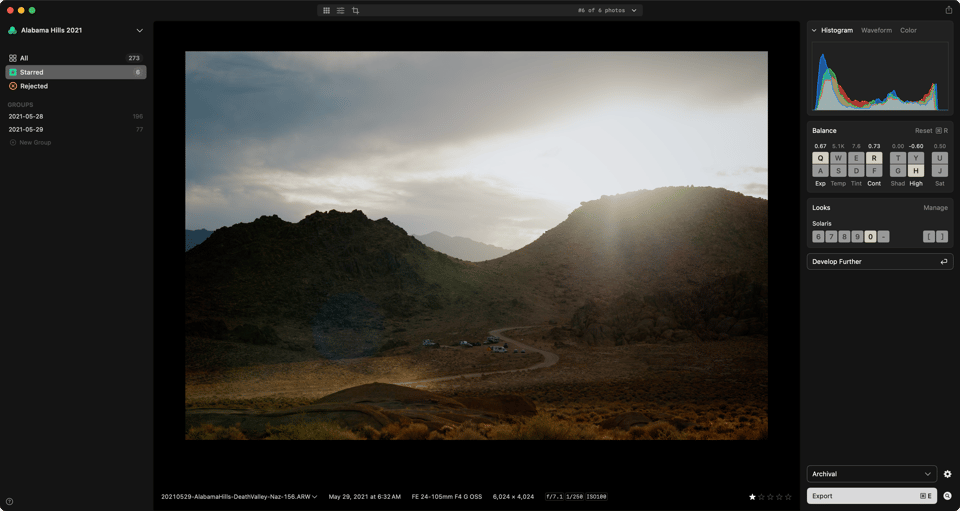 A photo of the desert and dramatic light and skies shown in the app against black.