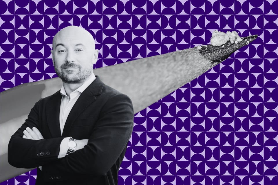 A white male professor in a suit with a watch on his right wrist. Behind him is a pencil tip with enough fentanyl to kill a person on a purple background