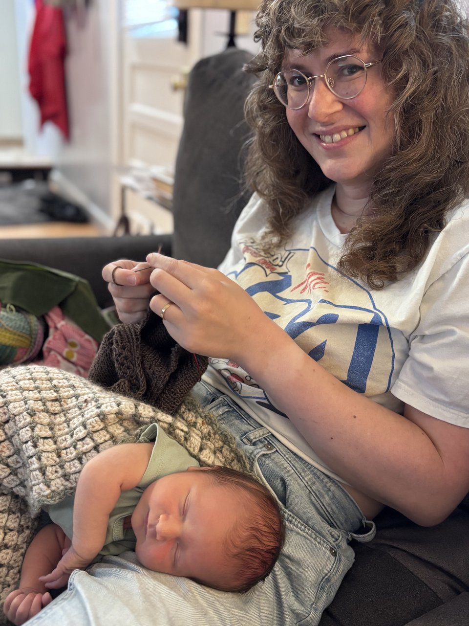 hannah knitting with a sleepy baby in her lap