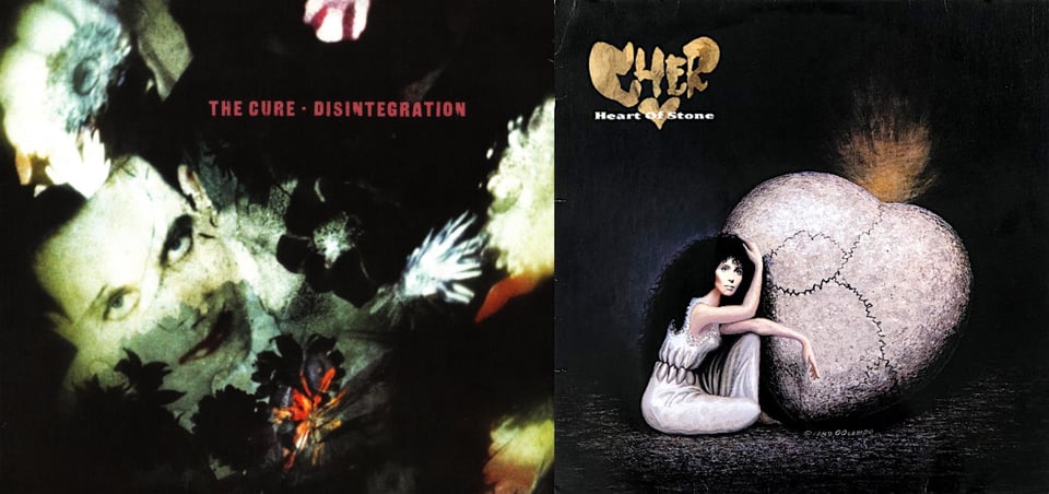 First pic: We see the face of The Cure singer Robert Smith, with pale white skin, black hair, black eyeshadow, and red lips. (He's one of the most Gothiest men alive.) Around him are images of flowers. The photo has a sense of distortion, because I believe it's actually a projection onto a wall or another surface. Second pic: A painting of Cher sitting next to a large heart-shaped stone. Cher is wearing a white dress that is cinched at the waist, creating a number of folds. The stone heart has a series of cracks running through it. With the way everything is arranged, it creates the image of a skull: the stone heart is the head part of the skull, Cher's face makes the eye, and the cinched folds of her dress make the teeth.