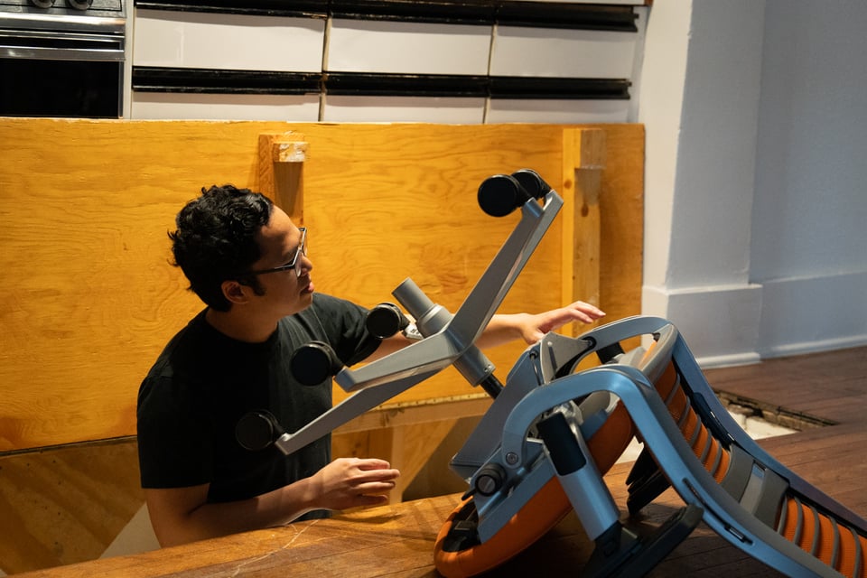 A man attempting to move a chair into the baptistry.