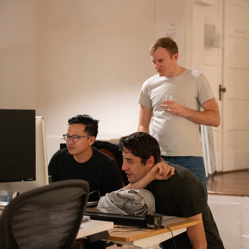 A group of people looking intently at a screen.