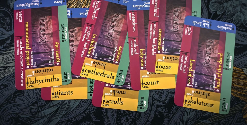 A spread of Downcrawl Deck cards showing prompts like labyrinths, giants, cathedrals, and scrolls.