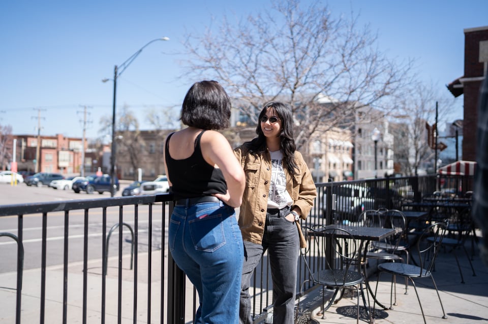 Michelle and Lexi talking outside an ice cream shop.
