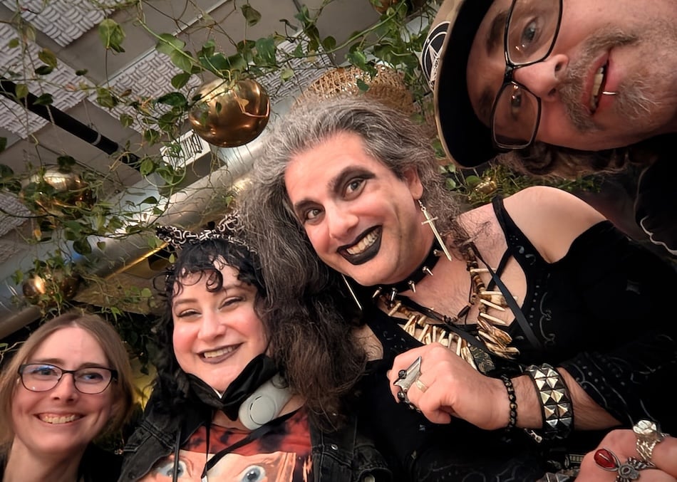 A photo of three lovely ladies and one cool dude at a bar