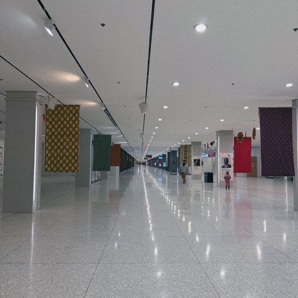 a seemingly infinitely stretching concourse with terrazzo floors