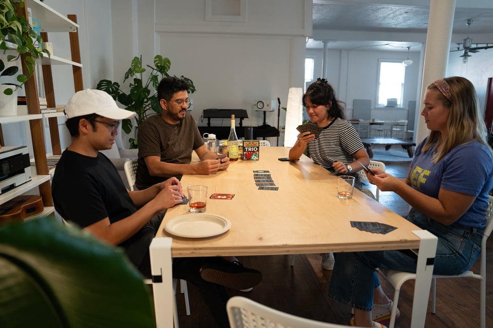 People sitting around a table playing a game.