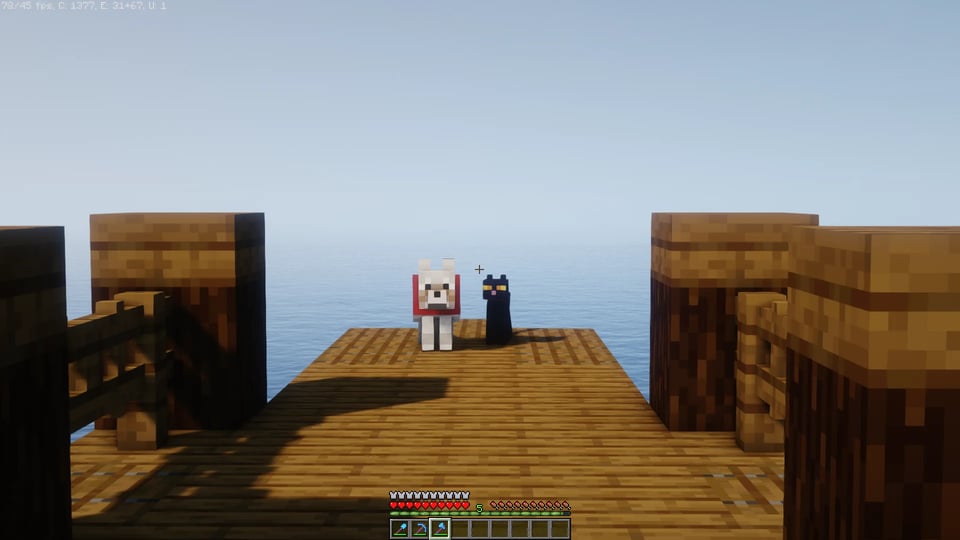 A dog and a cat made out of blocks sit on a dock, also made out of blocks.