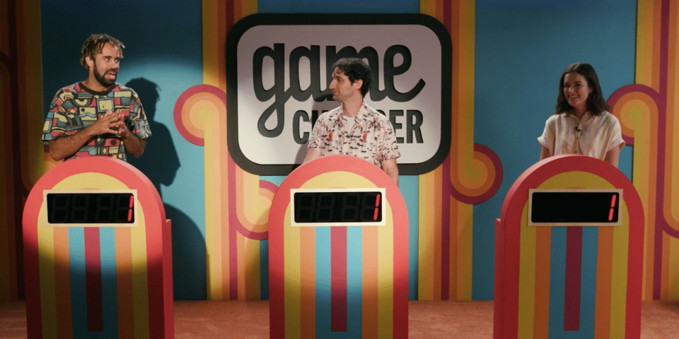 Three improvisers in a game show.