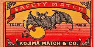 A matchbox cover for Kojima Match & Co with an engraving of a friendly-looking bad