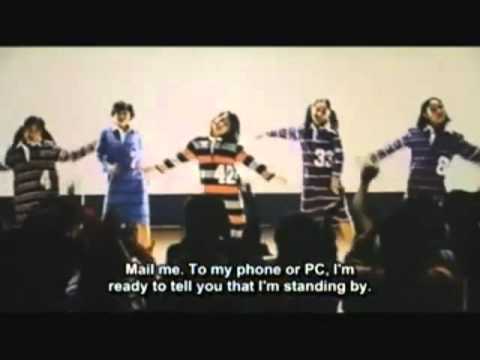 Five lovable girls in striped pyjamas with big numbers on them - 42! 33! - are singing in front of a packed audience: "Mail me. To my phone or PC. I'm ready to tell you that I am standing by."