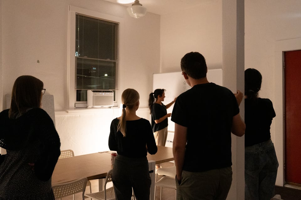 A group looking at a whiteboard.