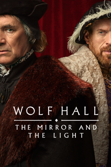 This promotional image for Wolf Hall: The Mirror and the Light features two stern-looking men dressed in rich Tudor-era clothing, standing in front of a deep red velvet backdrop. The man on the left wears a black hat and cloak with a fur mantle, while the man on the right wears a luxurious cream fur-lined garment and ornate gold-embroidered clothing. Both men are partially turned toward the camera, their expressions serious and intense. The title text is centered near the bottom in elegant, serifed white font: WOLF HALL followed by THE MIRROR AND THE LIGHT, with a small diamond divider in between.