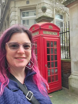 Meredith poses with a traditional red telephone box.