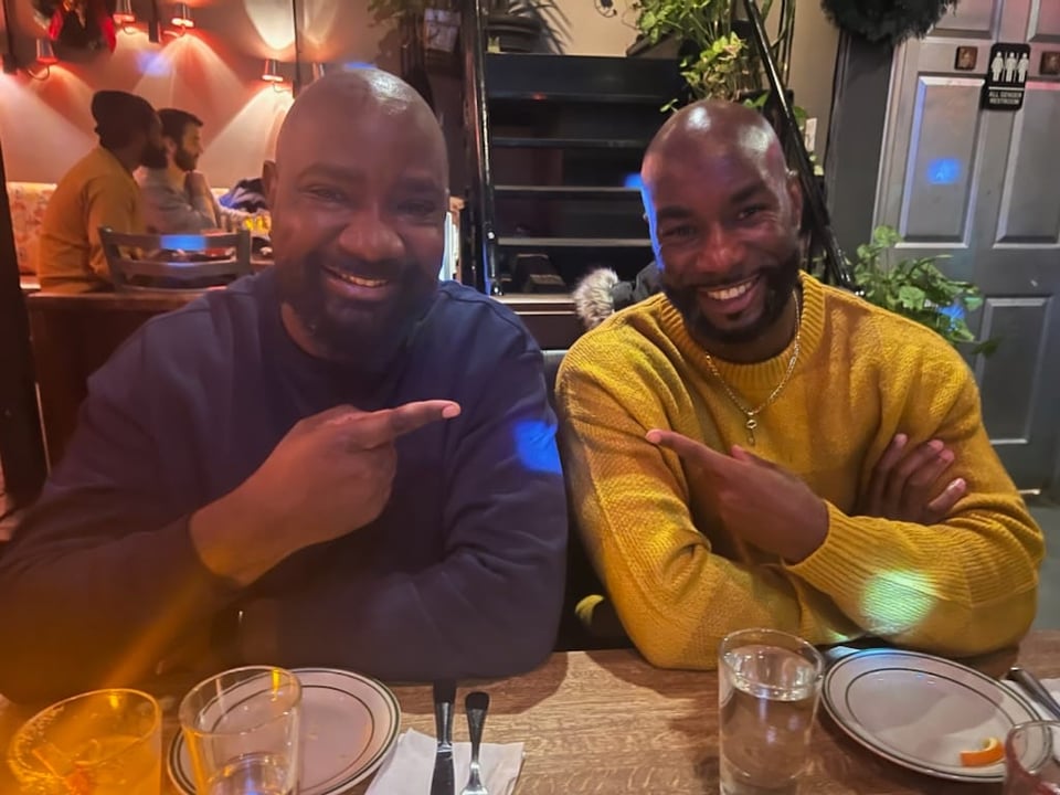 Two bearded Black men posing for a picture