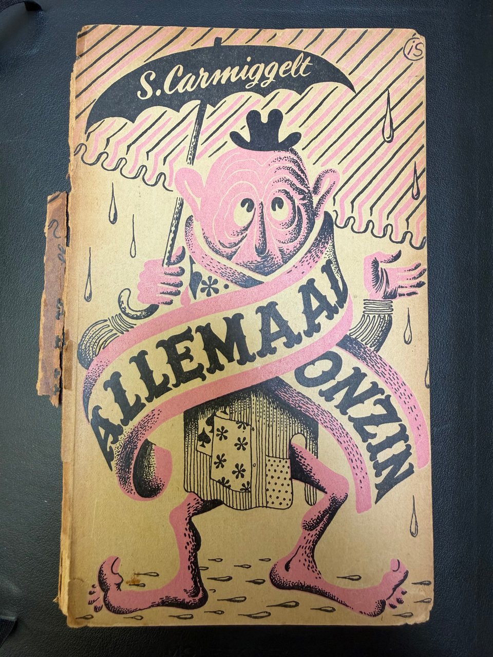 Very old yellowed book cover. Illustration in pink and black of a figure wearing a scarf with letters. The spine is falling apart. Not an expensive title for sure.