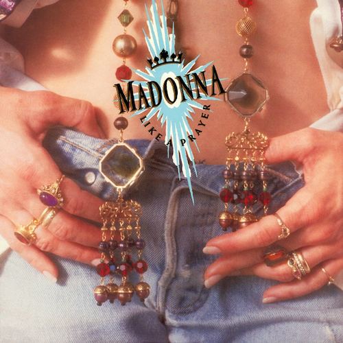 A close up of Madonna's exposed belly and crotch of her jeans. The top buttons of the jeans are unbuttoned. Madonna's hands are on top of her jeans, her thumbs tucked inside. Two long pieces of jewelry hang (presumably) from her neck, strings with various gems and baubles and rings on them. They probably have Catholic significance but I do not know what. If you want to see Madonna's face, cf. Ciccone Youth, THE WHITEY ALBUM.