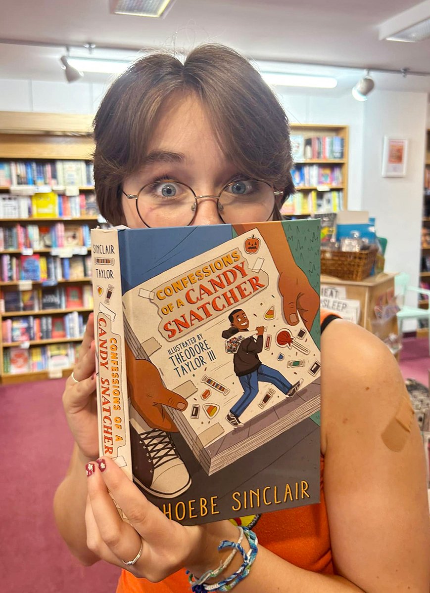 young woman looks excited holding book