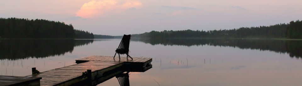 a dock on a lake at sunset