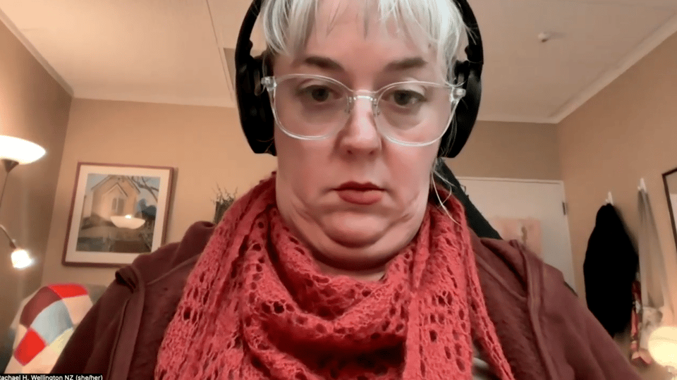 Same Rachael, frowning down at screen, many chins