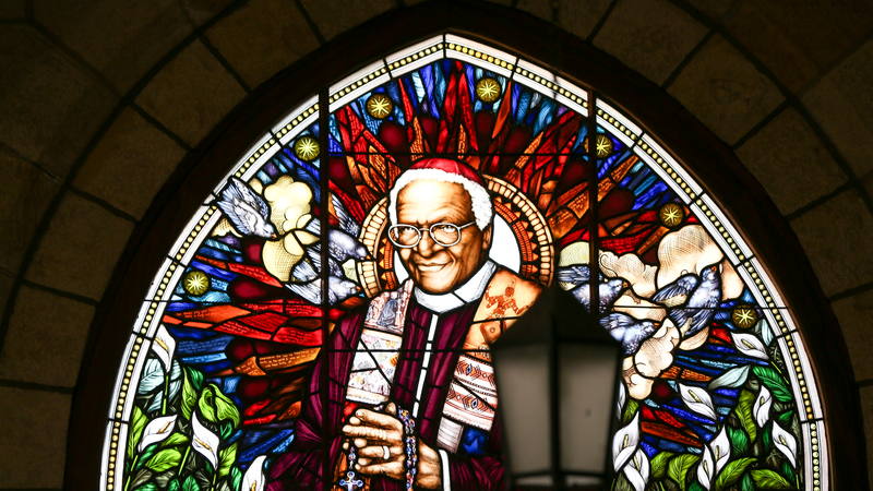 a stained glass window showing a black man in bishop's attire and a priest's stole sometimes seen at All Saints