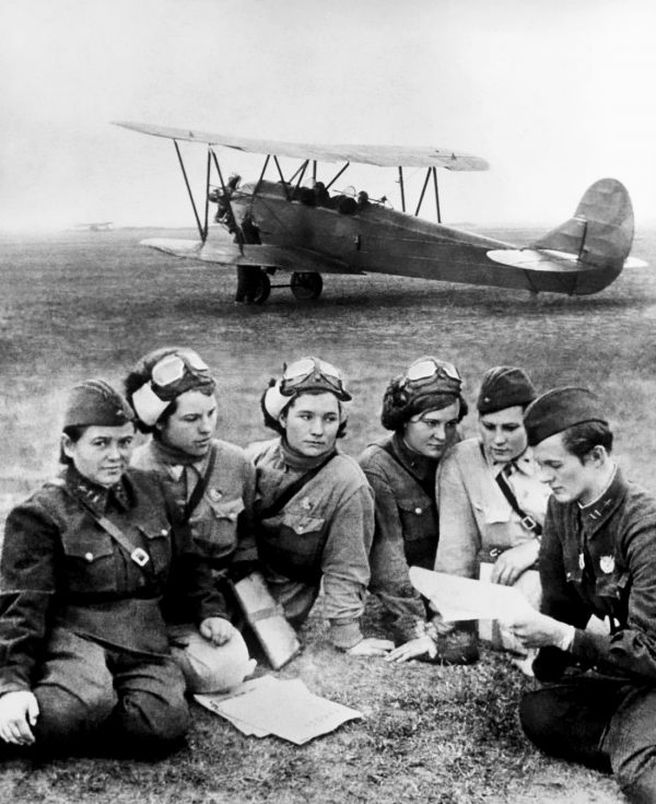 the 588th night witches sat in front of one of their planes