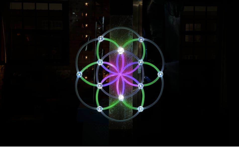 Geometric shape illuminated with green and purple