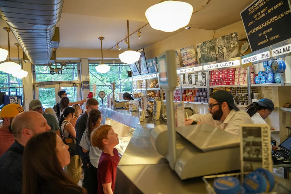 Customers order food over the counter at Russ & Daughters.