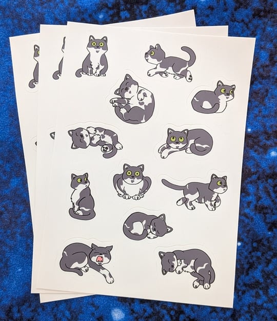 a sheet of a dozen stickers of a cartoony grey and white cat with green eyes in various positions. She's round and kind of stubby, with no thoughts behind those eyes.