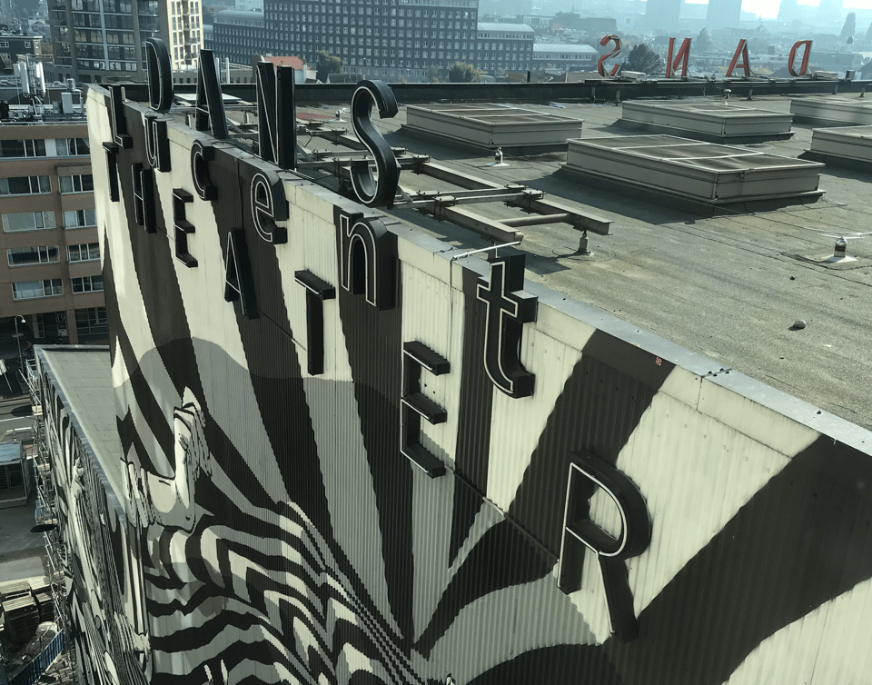 North East facade of the NDT theater by OMA. Mural by Harmsma and Jelmer Noordeman, lettering design by Karel Martens. Photo 2021.