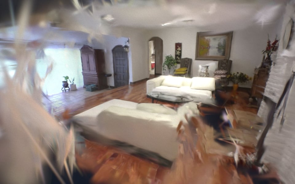 A view of a room with a bed and a sofa, edges blurred and dream-like